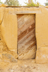 Wooden door in a wall in the village of Faiyum.