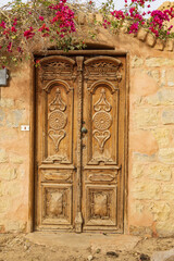 Wooden door in a wall in the village of Faiyum.