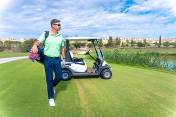 Man in the Buggy with the bag of clubs looking at the course, golf club, driver, iron, pitching