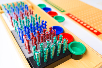 Detail of pins and beans on a montessori board to perform mathematical divisions.