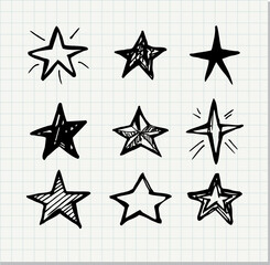 Set of black hand drawn doodle star isolated on paper background.