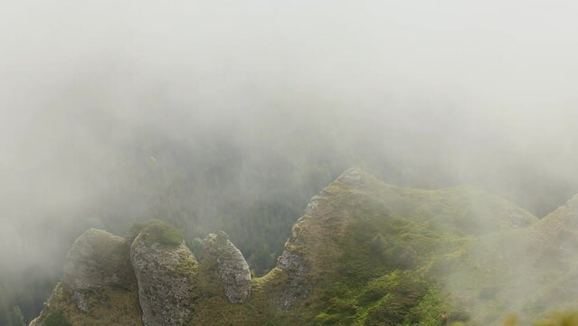 Aerial shot of the Ciuc mountain range in Romania on a foggy day