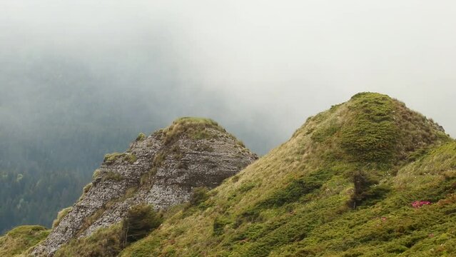 Shot of the Ciuc mountain range in Romania on a foggy day