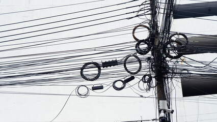 Signal line cables tangled on pole of chaotic line on electric pole on walking street,tangled...