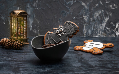a postcard with glazed gingerbread in the style of halloween, fir cones and a glowing lantern