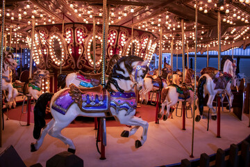 Fototapeta na wymiar festival beach boardwalk merry-go-round horseback ride