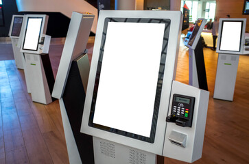 Blank white mockup background texture template of a kiosk machine with a touch screen and an attached POS machine. Copy space on a smart interactive machine service device for customer self-checkout. - obrazy, fototapety, plakaty