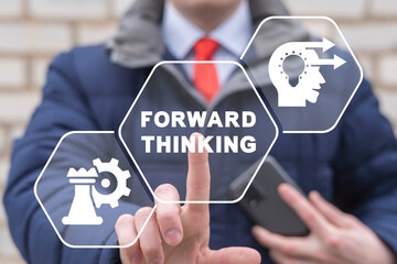 Businessman using virtual touchscreen presses inscription: FORWARD THINKING. Concept of forward thinking.