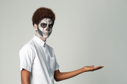 painted catrin teenager, with afro hair isolated with hand