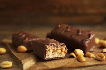 Chocolate bars with caramel, nuts and nougat on table, closeup
