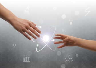 Closeup view of people and virtual model of atom on light grey background