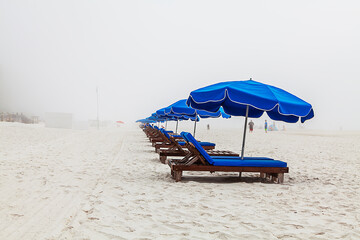 Blue Beach Loungers A foggy day on the beach leaves these beach lounger chairs ready but vacant. Gulf Shores Alabama