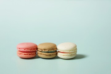 Colorful of sweet French macaroons on pastel color background,copy space.