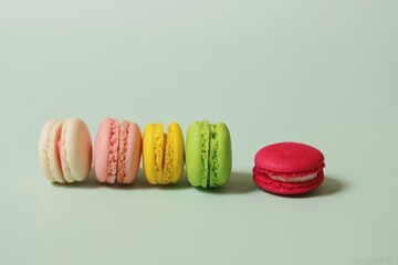 Colorful of sweet French macaroons on pastel color background,copy space.