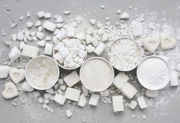 Mix of white refined sugar varieties: granulated, cubes, candies, hearts - obrazy, fototapety, plakaty