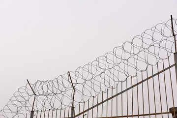 A fence with barbed wire. The concept is mobilization, closing the borders.