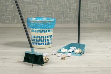 Cleaning of garbage in the room with a dustpan and a brush with a handle. - obrazy, fototapety, plakaty