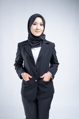 Portrait of an attractive Muslim woman wearing business attire and hijab with a corporate pose isolated on white background. For image cut-out for technology, business or finance.