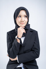 Portrait of an attractive Muslim woman wearing business attire and hijab with a corporate pose isolated on white background. For image cut-out for technology, business or finance.