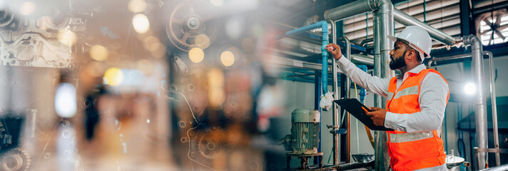 Professional engineering man in protective safety uniform and white hardhat working with clipboard at factory, Banner cover design.