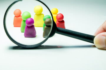 Employee recruitment concept, clay doll and magnifying glass represent the concept of recruiting personnel to participate in the event. 