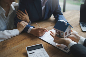 Real estate agent and couple enter into contracts for the sale of houses and land Approval of a contract to buy and sell a house Offers mortgage loans and home insurance ideas.