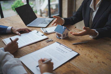 Real estate agent and couple enter into contracts for the sale of houses and land Approval of a contract to buy and sell a house Offers mortgage loans and home insurance ideas.