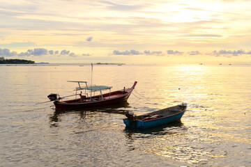 Naklejka na ściany i meble The fishing boat is in the Pattaya sea at sunset is beautifull