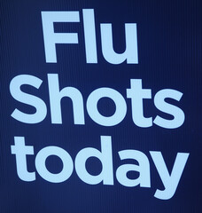 Flu shots today sign displayed outside.