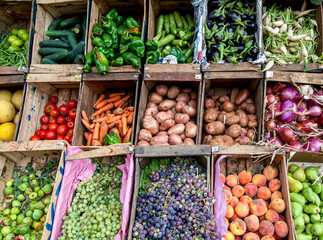 A selection of fresh fruit and vegetables packed in crates for sale on the roadside in the High Atlas Mountain town of Imlil in Morocco.
