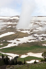 spring, mountains, awakenings in nature on subalpine meadows, remnants of snow cover.