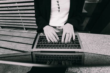 Close up image of woman hands typing on laptop.
