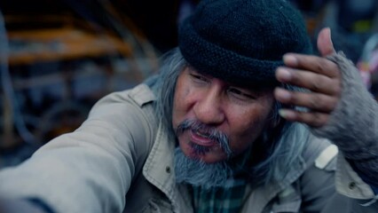 4K, Poverty homeless man with a beard begging for money healthy care, lifestyle aged man witretirement social problem from financial crisis unemployment without family, vagrant tramp man on the street