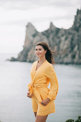 Fototapeta na wymiar A woman with stunning views of the mountains and the sea. Enjoying nature. Travel lifestyle concept.
