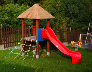 playground with a rocking horse and a slide