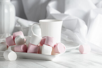 Pink and white marshmallows on a white table.