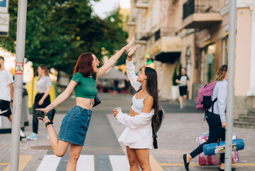 Two students high five to teach others after successful work together