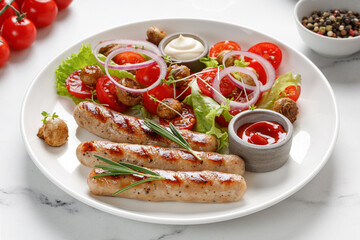 Grilled sausages with sauces, rosemary and salad with tomatoes on a white plate. Dish, dinner idea.