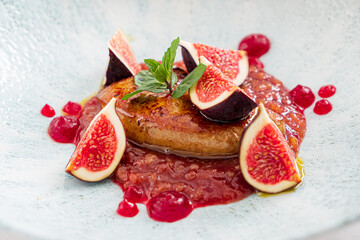 Rose roasted duck with fig  and drops of red wine sauce on a white plate, festive christmas dinner, copy space, high angle view from above, selected focus