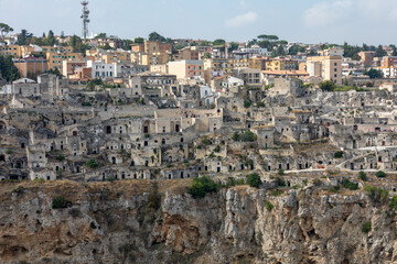 Naklejka premium Panoramic view of Sassi di Matera a historic district in the city of Matera, well-known for their ancient cave dwellings from the Belvedere di Murgia Timone, Basilicata, Italy