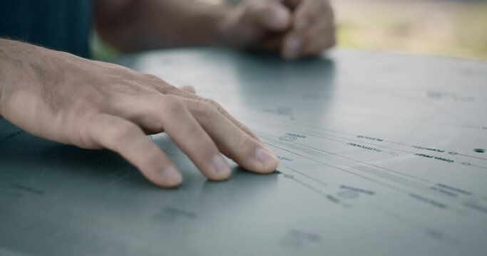 Closeup shot of man hiker hands and finger touching on the metal mountain map on the top of the hill Kum in Slovenia