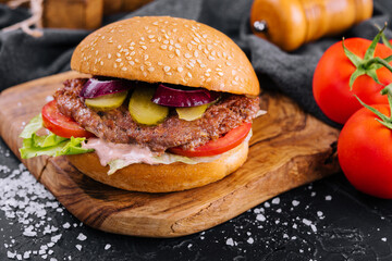 Close-up of home made burger on wooden tray