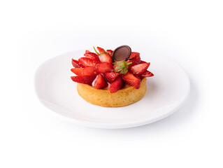 Tartlet with strawberry on white plate