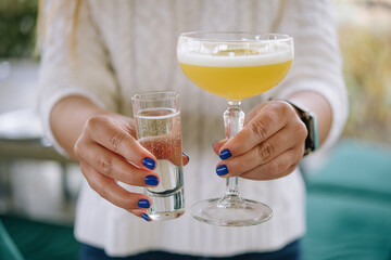 Glass of star martini in the hands of a girl