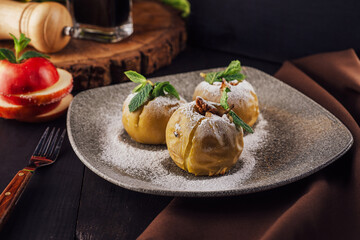 Baked apples stuffed with walnuts on plate