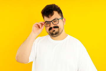 Concept of people, young fat man on yellow background