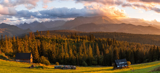 Panorama of Sunset in Carpathian Mountains. Golden Hour light over nature landscape