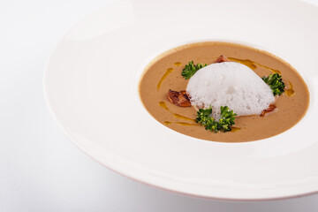 Creamy mushroom soup with champignons isolated