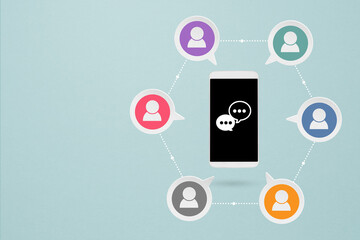 Concept of online communication or social networking. Mobile phone and grunge white  speech bubbles paper cut with multi color linked people icon on grunge background