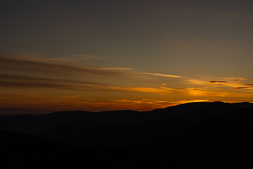 Sunset in mountains in summer landscape